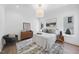 Well-lit bedroom with white walls, hardwood floors, an area rug and modern furnishings at 3410 Bradley Pl, Raleigh, NC 27607