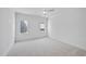 Bright bedroom boasts neutral carpeting, modern ceiling fan, and plenty of natural light from the two windows at 3410 Bradley Pl, Raleigh, NC 27607
