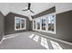 This bright, carpeted bedroom features a ceiling fan and three large windows at 3410 Bradley Pl, Raleigh, NC 27607