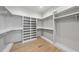 Spacious walk-in closet with shelving, rods, and hardwood floors for organized storage at 3410 Bradley Pl, Raleigh, NC 27607