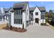 Stunning two-story home with a brick facade, a manicured lawn, and a paved driveway at 3410 Bradley Pl, Raleigh, NC 27607