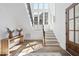 Bright foyer with hardwood floors, staircase, white walls, and modern decor at 3410 Bradley Pl, Raleigh, NC 27607
