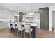 Spacious kitchen island with barstool seating, pendant lights, and hardwood flooring at 3410 Bradley Pl, Raleigh, NC 27607