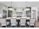 Modern kitchen featuring a large island with seating, pendant lighting, and custom cabinetry at 3410 Bradley Pl, Raleigh, NC 27607
