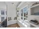 Bright window nook offers open shelving, cozy seating with throw pillows, and lots of natural light at 3410 Bradley Pl, Raleigh, NC 27607