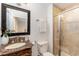 Well-lit bathroom with a vanity, an ornate framed mirror, toilet, and a glass enclosed walk-in shower at 42 Oakwood Dr, Chapel Hill, NC 27517