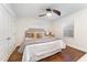 Cozy bedroom with hardwood floors, neutral walls, large window with blinds, and ceiling fan at 42 Oakwood Dr, Chapel Hill, NC 27517