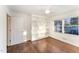 Bedroom with a large window, hardwood floors, a ceiling fan, and built-in shelves at 42 Oakwood Dr, Chapel Hill, NC 27517