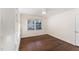 Bedroom featuring hardwood floors, built-in shelves, and bright window with blinds at 42 Oakwood Dr, Chapel Hill, NC 27517