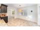 Bright breakfast nook features tile floors, a modern light fixture, and a beautiful view of the outdoors at 42 Oakwood Dr, Chapel Hill, NC 27517