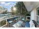 Cozy wooden deck with outdoor seating and a view of the serene, tree-lined backyard at 42 Oakwood Dr, Chapel Hill, NC 27517