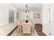 Bright dining room featuring modern chandelier, stylish table set, and natural lighting at 42 Oakwood Dr, Chapel Hill, NC 27517
