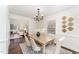 Bright dining room featuring modern chandelier, stylish table set, and seamless view to living room at 42 Oakwood Dr, Chapel Hill, NC 27517