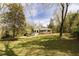 Classic brick home surrounded by lush landscaping and mature trees on a spacious lot at 42 Oakwood Dr, Chapel Hill, NC 27517