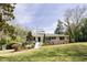 Charming, traditional-style home with white brick, manicured lawn, and inviting curb appeal at 42 Oakwood Dr, Chapel Hill, NC 27517