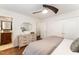 Bright main bedroom featuring a modern ceiling fan, wooden floors, and a dresser with an ornate mirror at 42 Oakwood Dr, Chapel Hill, NC 27517