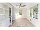 Office space featuring built-in shelving, a ceiling fan, and bright natural light from the windows at 42 Oakwood Dr, Chapel Hill, NC 27517