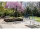 Neighborhood playground includes swings, picnic tables, benches, and mature shade trees at 42 Oakwood Dr, Chapel Hill, NC 27517