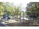 Outdoor community playground with swings, slide, climbing structure and benches at 42 Oakwood Dr, Chapel Hill, NC 27517