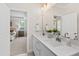 Elegant bathroom with double vanity, quartz countertops, and a view into the Primary bedroom at 123 Wichita Way, Louisburg, NC 27549
