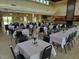 Spacious event space featuring set tables, a fireplace, and ample room for gatherings and celebrations at 123 Wichita Way, Louisburg, NC 27549