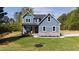 Charming two-story home with blue siding, stone accents and manicured lawn and craftsman details at 123 Wichita Way, Louisburg, NC 27549