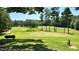 Expansive golf course view featuring a well-manicured green, sand trap, and towering pine trees at 123 Wichita Way, Louisburg, NC 27549