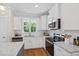 A close view of the kitchen featuring stainless appliances, white cabinets and granite counter tops at 123 Wichita Way, Louisburg, NC 27549