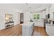 Bright kitchen features white cabinetry, granite countertops, island, and stainless appliances at 123 Wichita Way, Louisburg, NC 27549