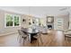 Open-concept living area with hardwood floors, stone fireplace, and adjacent dining space bathed in natural light at 123 Wichita Way, Louisburg, NC 27549