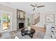 Bright living space with a stone fireplace, access to a screened porch, and staircase leading to the upper level at 123 Wichita Way, Louisburg, NC 27549