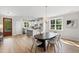 Hardwood floors connect living and dining spaces near the kitchen with an adjacent outdoor view at 123 Wichita Way, Louisburg, NC 27549