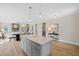 Open concept kitchen features granite island, pendant lighting, and open to living room and dining at 123 Wichita Way, Louisburg, NC 27549