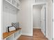 Mudroom with wood bench, storage, hooks, and a view into another room at 123 Wichita Way, Louisburg, NC 27549