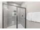 Modern walk-in shower featuring sleek tile and glass enclosure at 123 Wichita Way, Louisburg, NC 27549