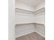 Spacious walk-in closet with ample shelving and carpeted floor at 123 Wichita Way, Louisburg, NC 27549