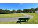 Scenic walking path through green space with a bench and a view of nature, perfect for relaxing strolls at 123 Wichita Way, Louisburg, NC 27549