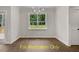 Bright dining room with hardwood floors and a large window at 137 Buckaroo Dr, Louisburg, NC 27549