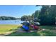 Wooden kayak and paddleboard rack by the lake, ready for summer fun at 137 Buckaroo Dr, Louisburg, NC 27549
