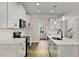 Bright kitchen featuring white cabinets, quartz countertops, and stainless steel appliances at 137 Buckaroo Dr, Louisburg, NC 27549