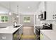 Open kitchen boasting white cabinets, quartz countertops, and a large island at 137 Buckaroo Dr, Louisburg, NC 27549