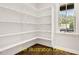 Built-in corner shelves in an office with hardwood floors and large window at 137 Buckaroo Dr, Louisburg, NC 27549