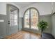 Charming entryway featuring arched windows, stylish door, and beadboard paneling offers elegance at 1409 Sedgefield St, Durham, NC 27705