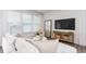 Well-lit living room featuring a white sofa, neutral decor, and large windows with blinds at 1823 Hinesley Dr, Durham, NC 27703