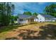 The backyard features lush greenery and the home's wooden porch at 235 Sequoia Dr, Louisburg, NC 27549