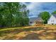 View of the home's backyard with a lawn and a wooden porch at 235 Sequoia Dr, Louisburg, NC 27549