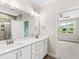 Elegant bathroom featuring double vanities, modern fixtures, and a separate shower at 235 Sequoia Dr, Louisburg, NC 27549