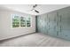 Comfortable bedroom with a large window, ceiling fan, and wainscotting on the walls at 235 Sequoia Dr, Louisburg, NC 27549
