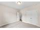 Bedroom featuring neutral carpet, a closet, and doors for easy access at 235 Sequoia Dr, Louisburg, NC 27549