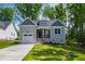 Charming craftsman home with gray siding, stone accents, and a well-manicured front yard at 235 Sequoia Dr, Louisburg, NC 27549